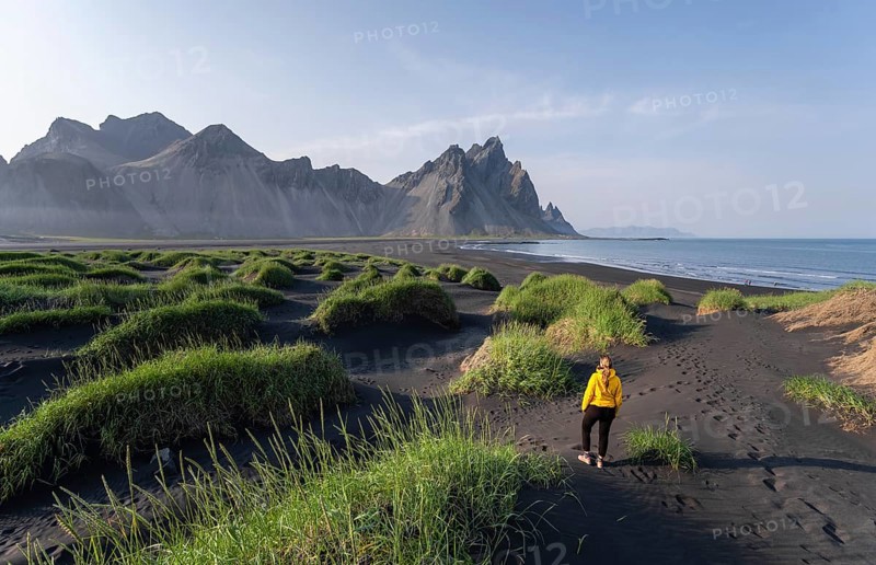 Young woman with rain jacket hiking