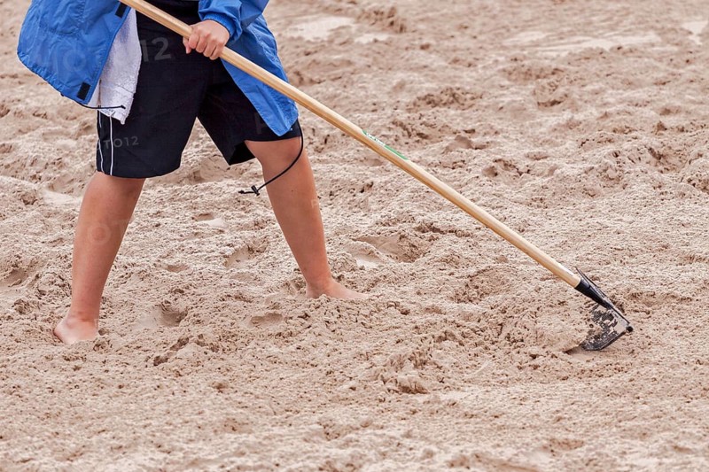 Raking the jumping pit for the long jump