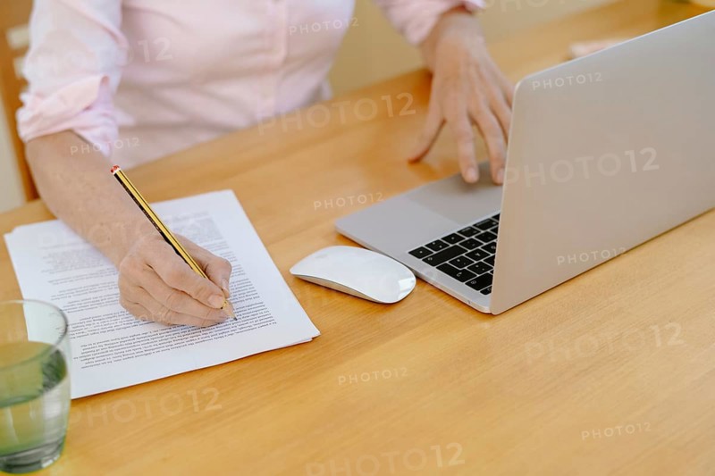 Woman proofreading at her desk