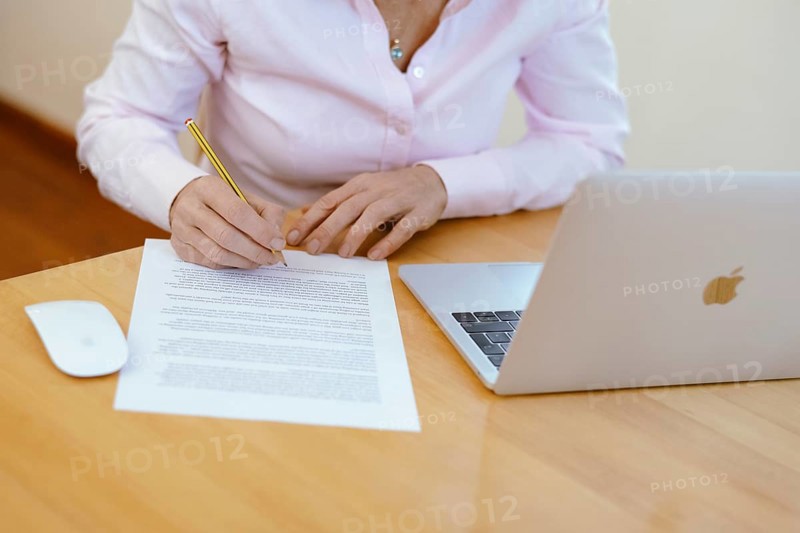Woman proofreading at her desk
