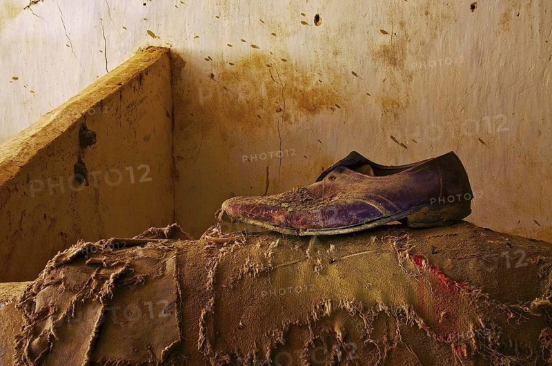 Brown low shoe for men stands on torn jute bag