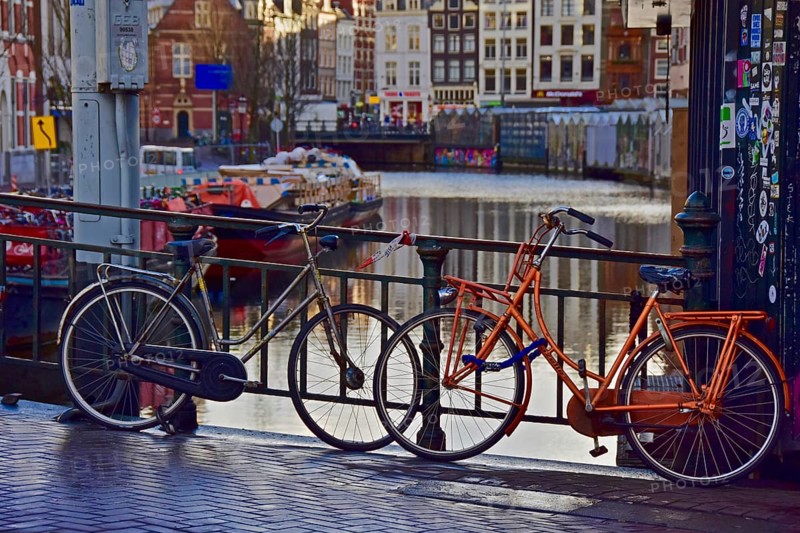 Dutch bicycles on bridge railings of a canal in Amsterdam
