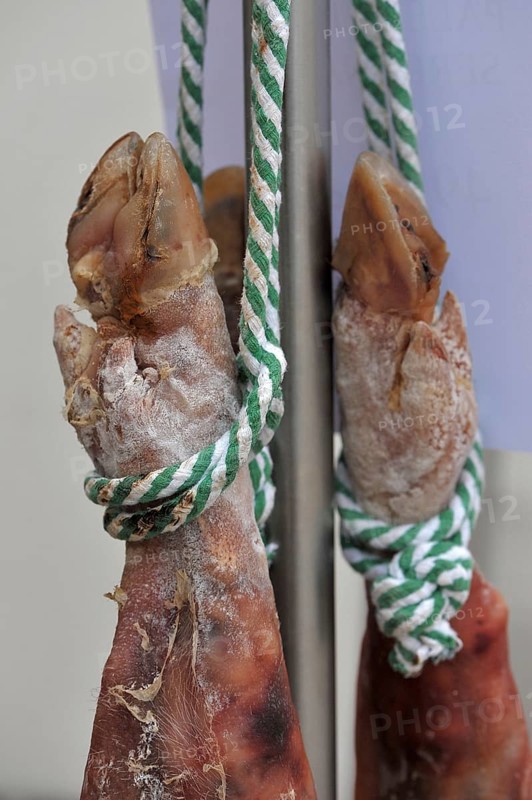 Suspended pork shanks on a rope