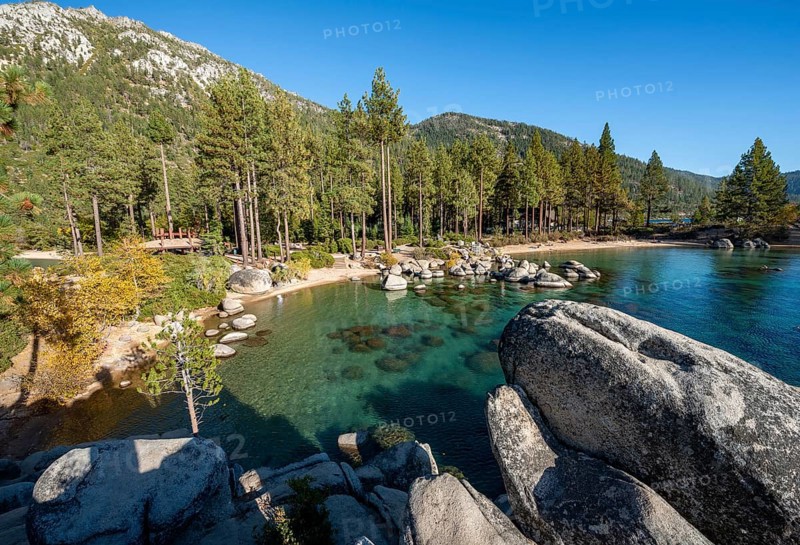 Sand beach and round stones in the water