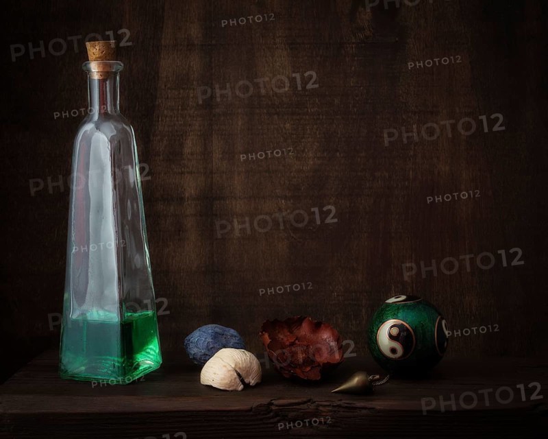 Still Life with Qi Gong Ball Next to Bottle with Green Liquid