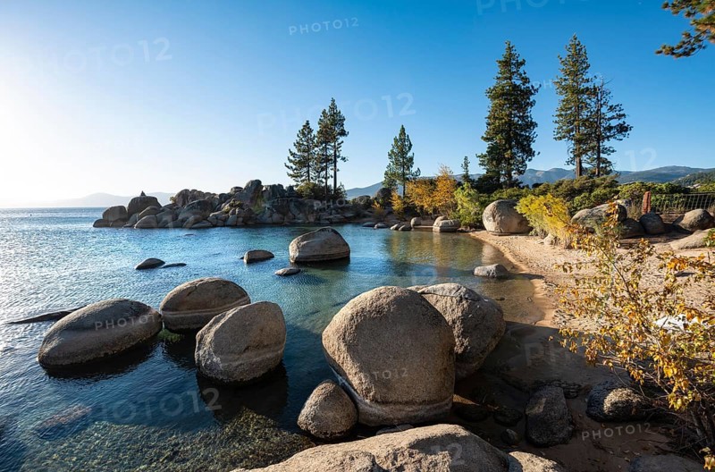 Sand beach and round stones in the water