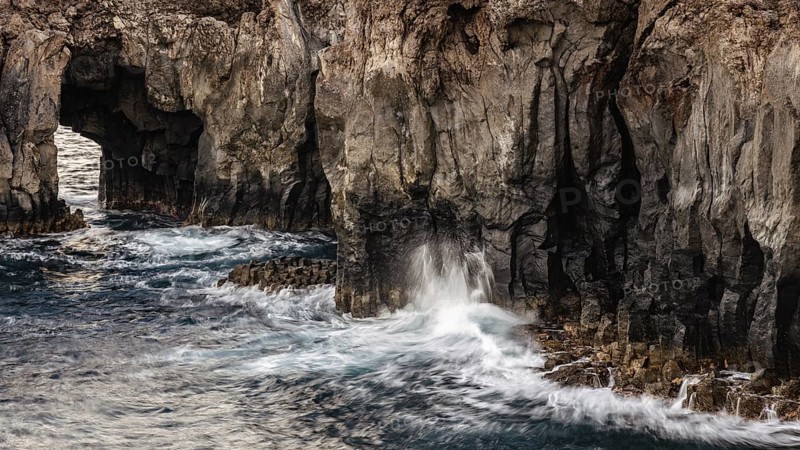 Surf at rocky lava coast