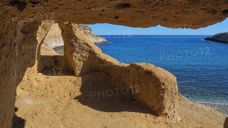 Bay with rock caves in the sandstone at Cabo Cope