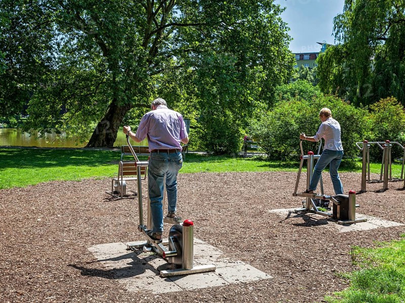Seniors exercising on outdoor fitness equipment at Lietzensee Park