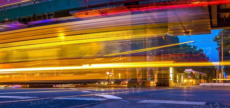 Moving trams at an intersection with a speed camera column