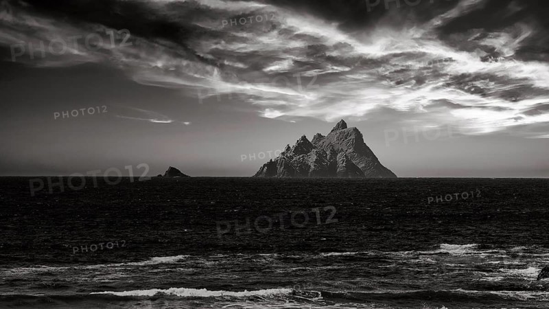 Two rocky islands in the sea at sunset