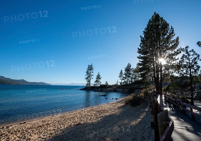 Wooden walkway on sandy beach with sun star