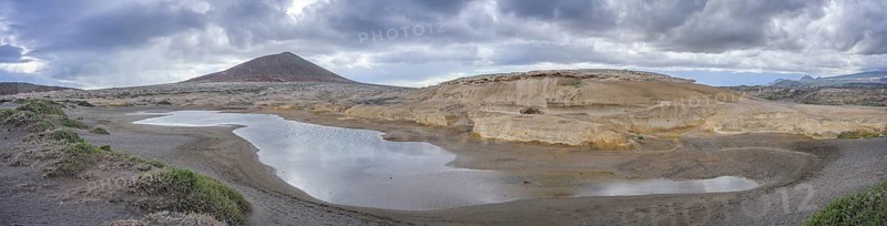 Sandstone structures and behind them the mountain Montana Roja