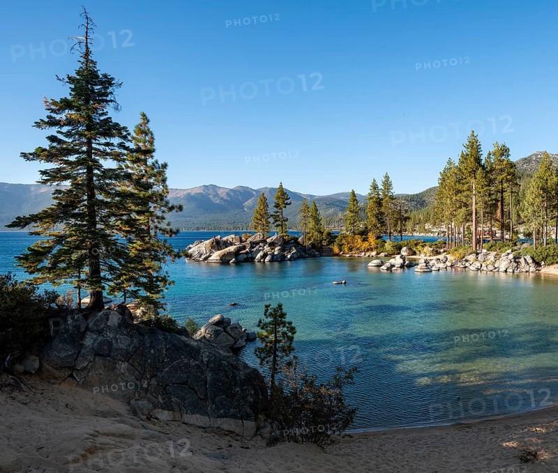 Sand beach and round stones in the water