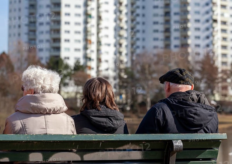 Seniors sitting on a park bench at the Segeluchbecken in the Maerkisches Viertel