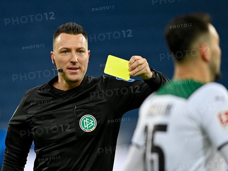Referee Sven Jablonski shows yellow card to Ramy Bensebaini Borussia Moenchengladbach BMG