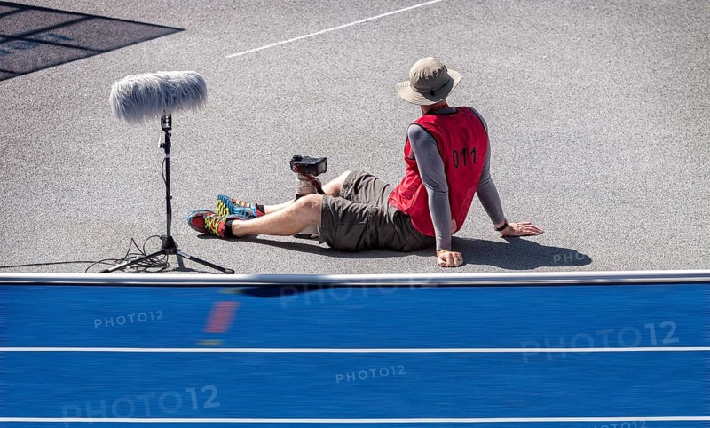 Photographer with red waistcoat during an athletics event at the Olympiastadion