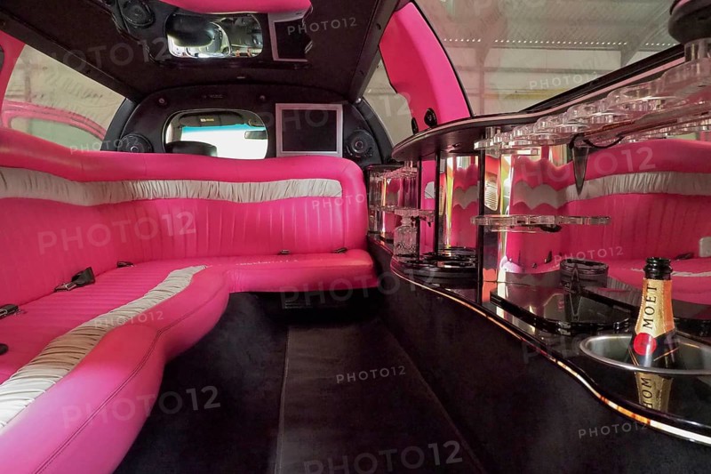 Luxury interior of a stretch limousine with pink upholstery
