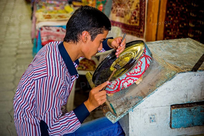 Boy driving metal bowl