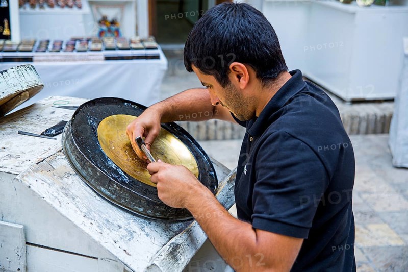 Man driving metal bowl