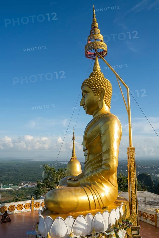 small golden pagoda on the temple hill in the evening
