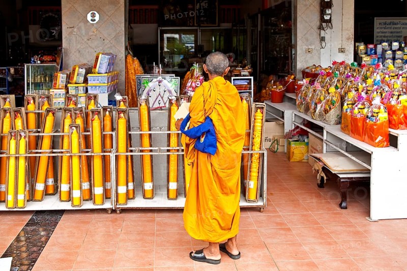 Monk in front of shop with temple requirements