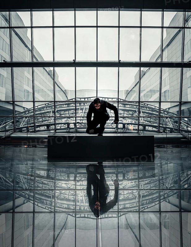 Man with Purge mask in a modern building