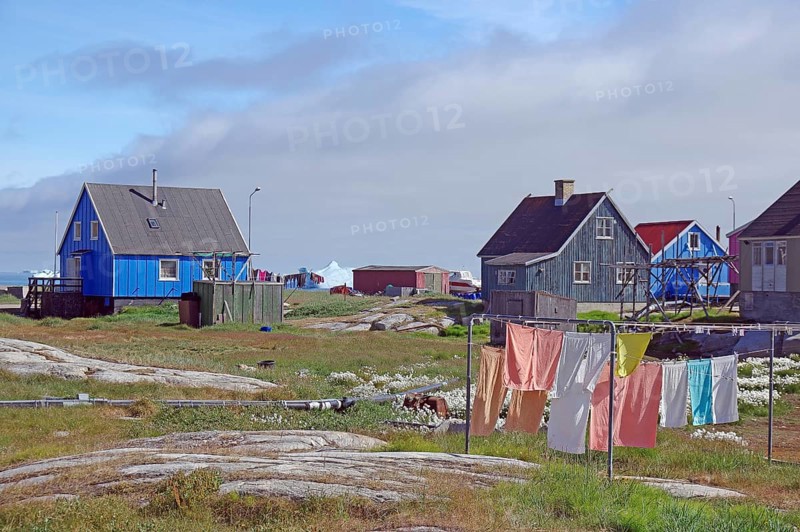 Laundry hanging in front of simple wooden houses