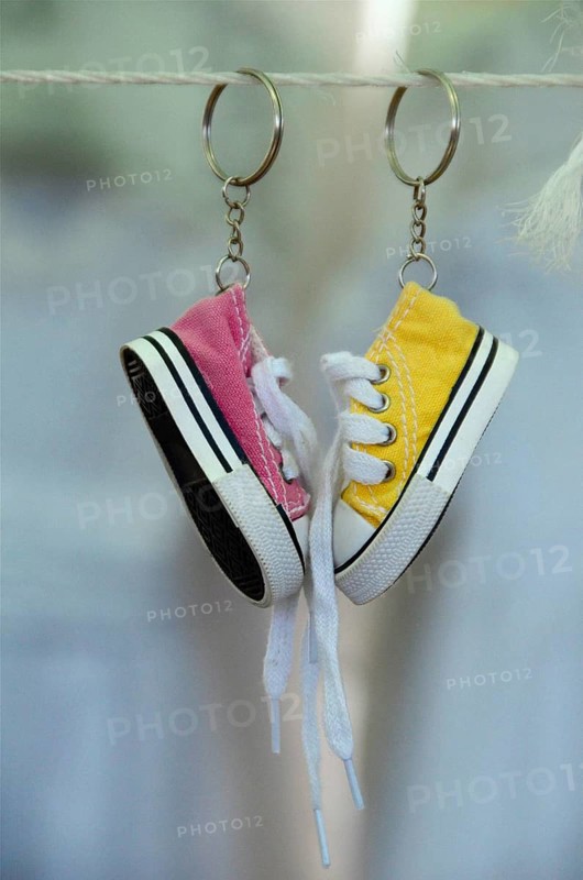 Sneakers as keychain on leash at market
