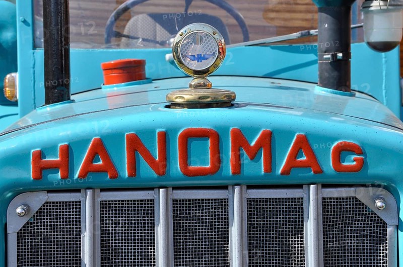 Hanomag logo with radiator figure on turquoise metal from tractor