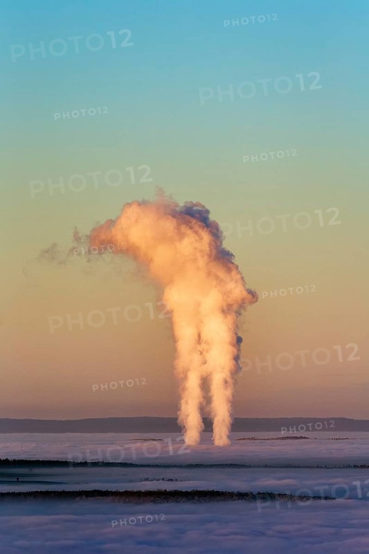 Two columns of steam rising from cloud cover