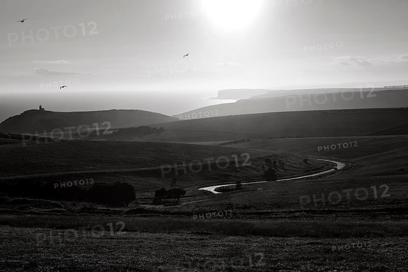 Winding country road with views of the coast and Belle Tout lighthouse
