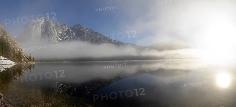 Fog clears in front of the Trisselwand at Lake Altaussee
