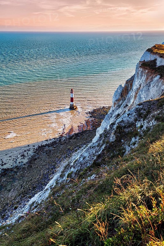 Red and white lighthouse in the sea