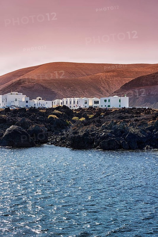 White houses on rocky lava coast