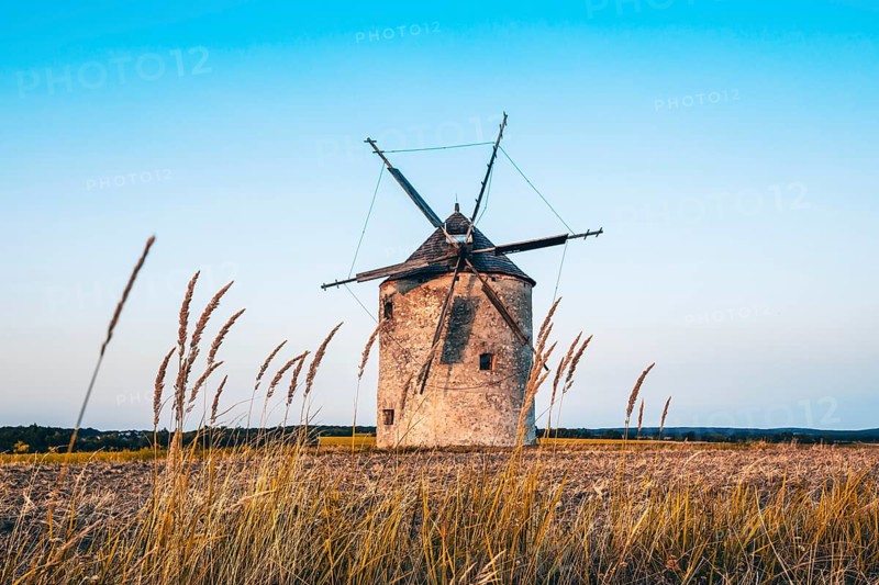The Old Windmill of Tes in the sunset with guests