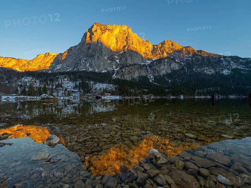 Evening sun illuminates the Trisselwand at Lake Altaussee