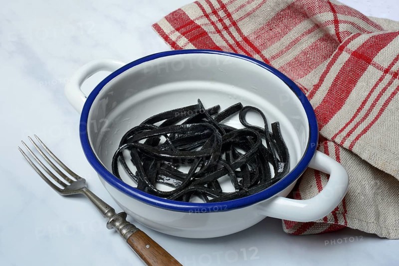 Black pasta with squid ink in bowl