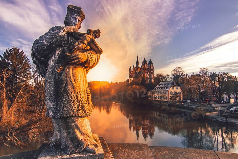 The statue of the bridge saint Nepomuk on the Old Lahn Bridge with the late Romanesque and early Gothic Limburg Cathedral of St. George
