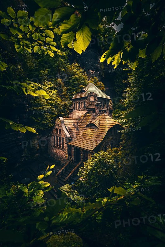 Old gasworks made of solid stone with stone steps in the middle of a gorge with forest and trees. Hrensko Czech Republic