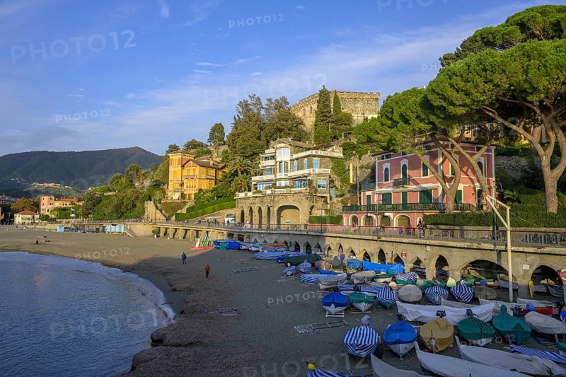 Covered fishing boats and the town beach