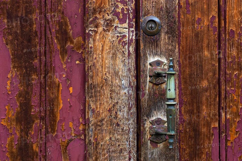 Wooden door with patina and brass handle