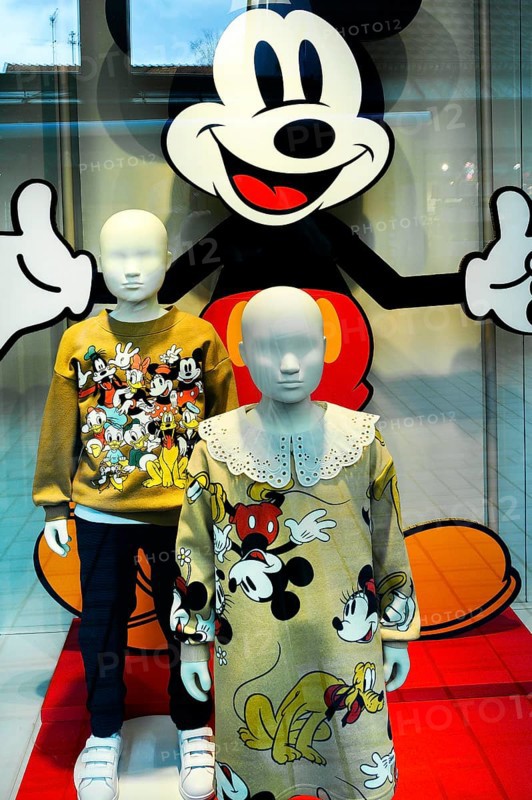 Shop window with children's fashion dolls in Mickey Mouse clothes