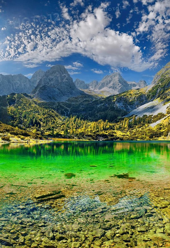 Turquoise Lake Seebensee and the mountain peak of the Tajakopf under a bizarre cloudy sky
