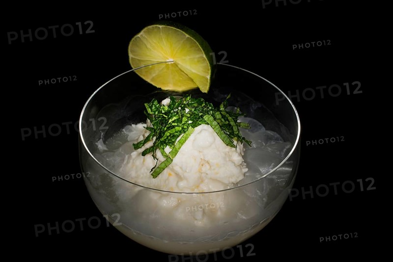 Lemon coconut sorbet with champagne and fresh mint in a glass