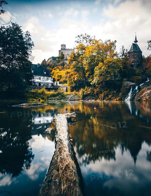 Pyrmonter mill at the waterfall of Elzbach with the castle Pyrmont in the back