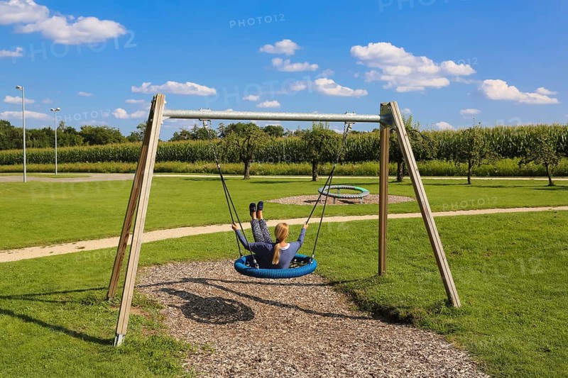 Woman on swing in the Garden of Eden