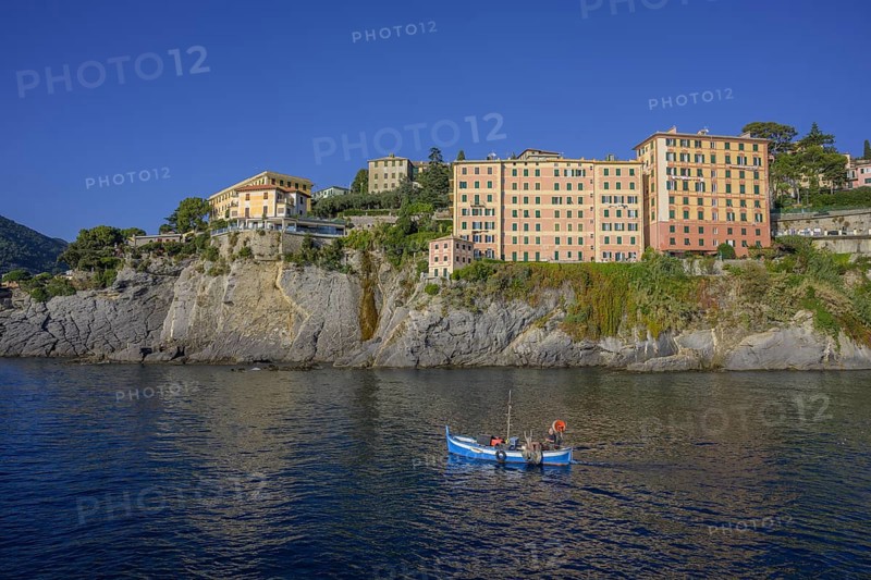 Historic skyscrapers and fishing boat leaving the port of