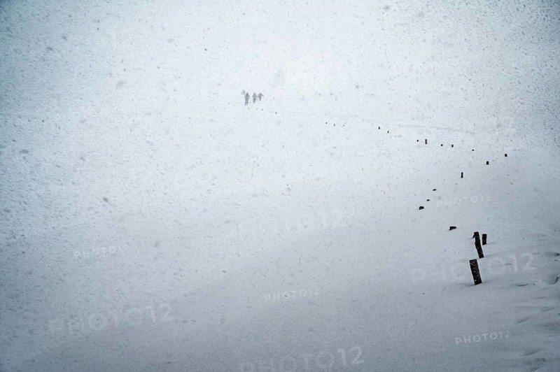 Ski tourers in heavy snowfall