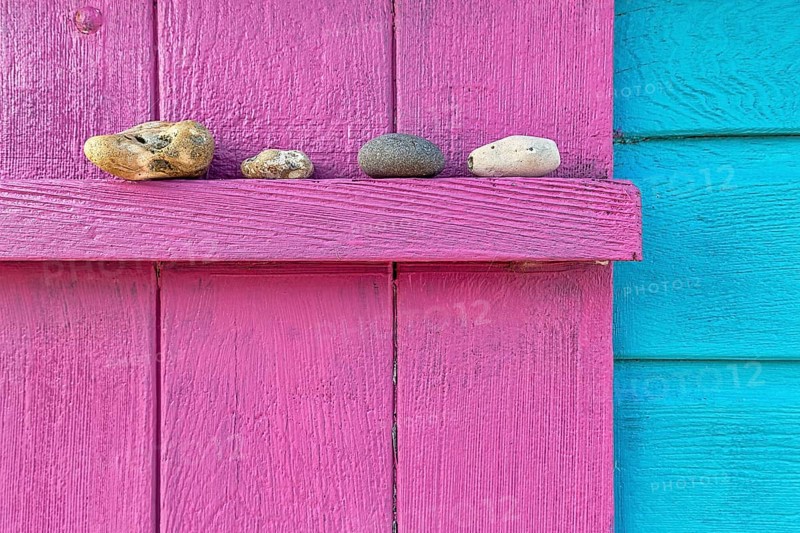 Four discarded stones on a beam
